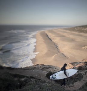 Surfer vor einer Klippe